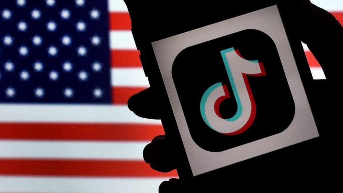 United states set to ban TikTok, A phone held against the national flag
